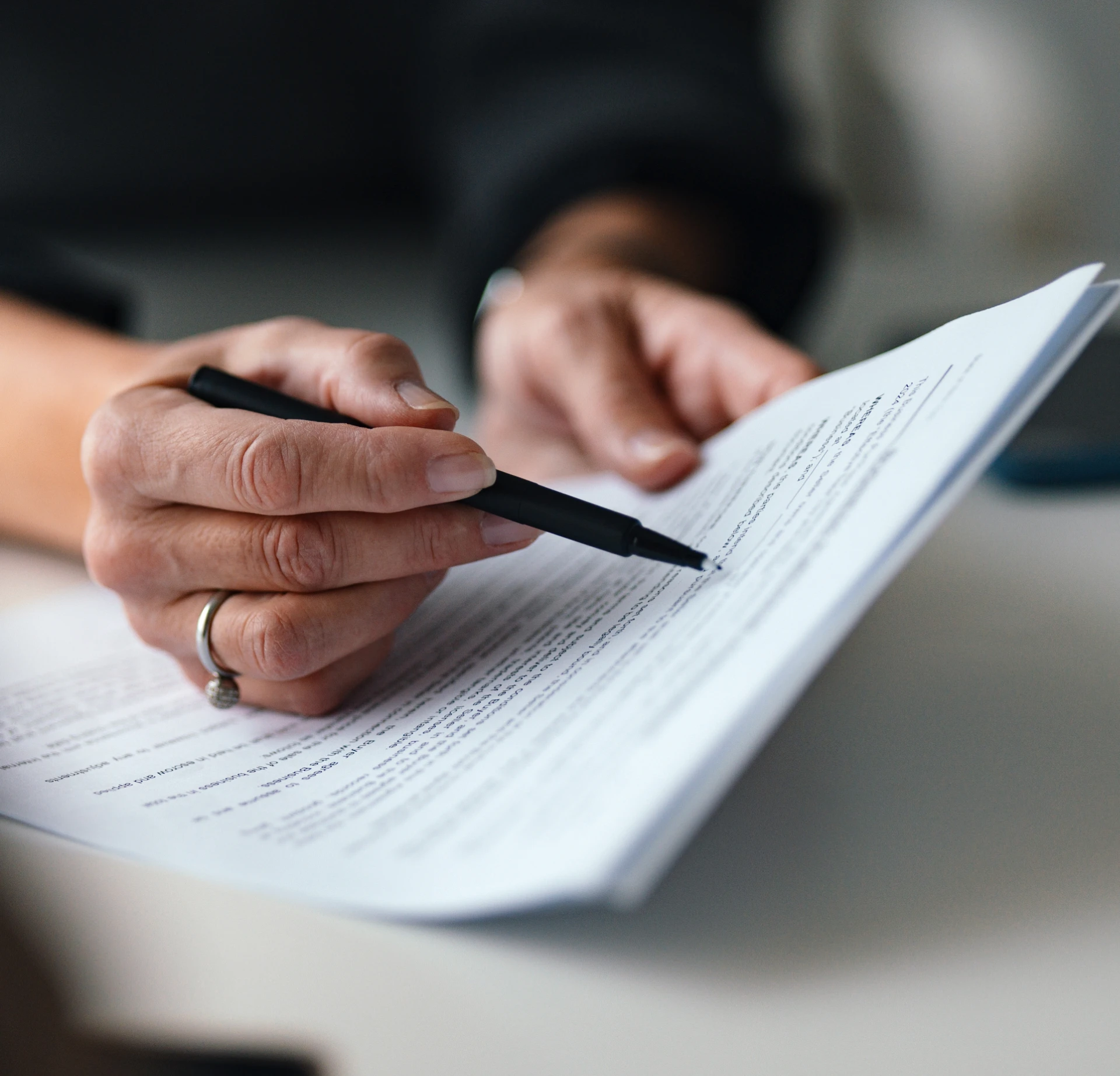 Person reviewing and marking a document